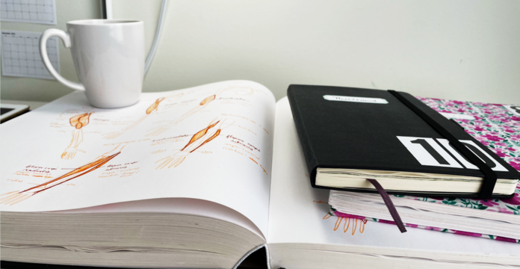 drawings in sketchbooks on desk